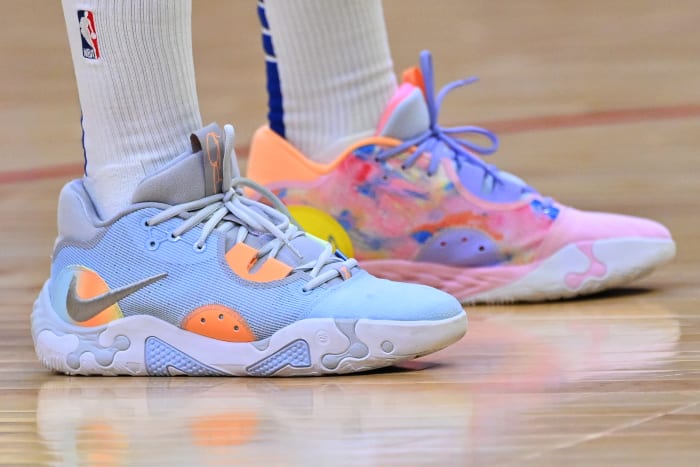 View of blue and pink Nike shoes.